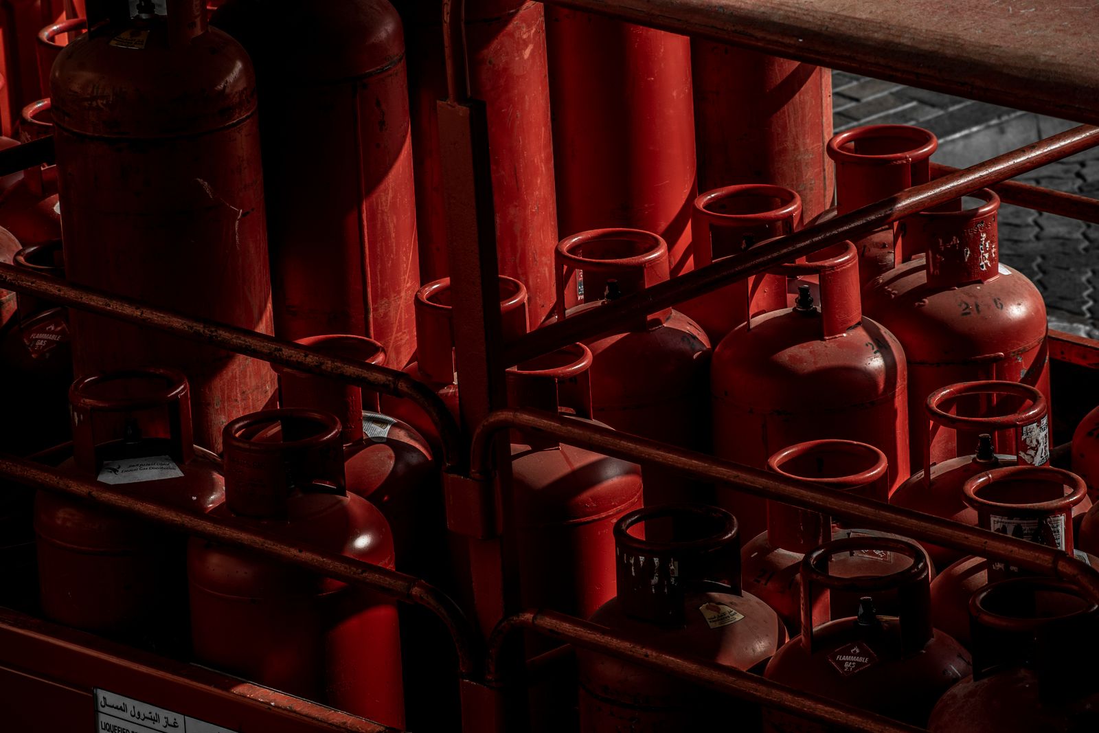 Racks of red LPG cylinders ready for delivery